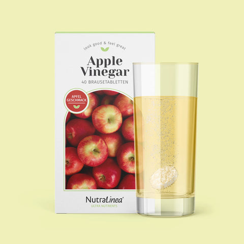 Box Apple Vinegar Apfel von NutraLinea daneben Glas mit Brausetablette