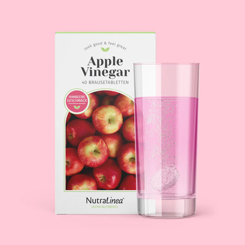 Box Apple Vinegar Himbeere von NutraLinea daneben Glas mit Brausetablette