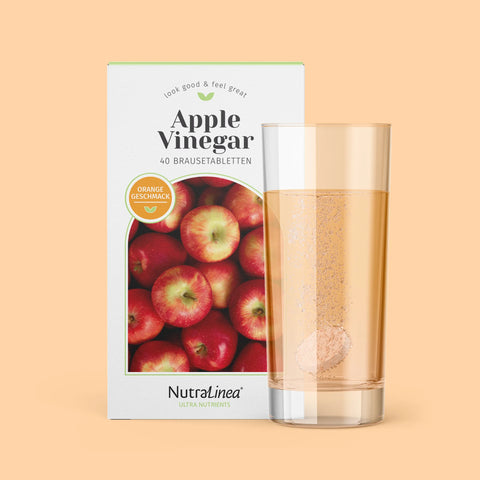 Box Apple Vinegar Orange von NutraLinea daneben Glas mit Brausetablette